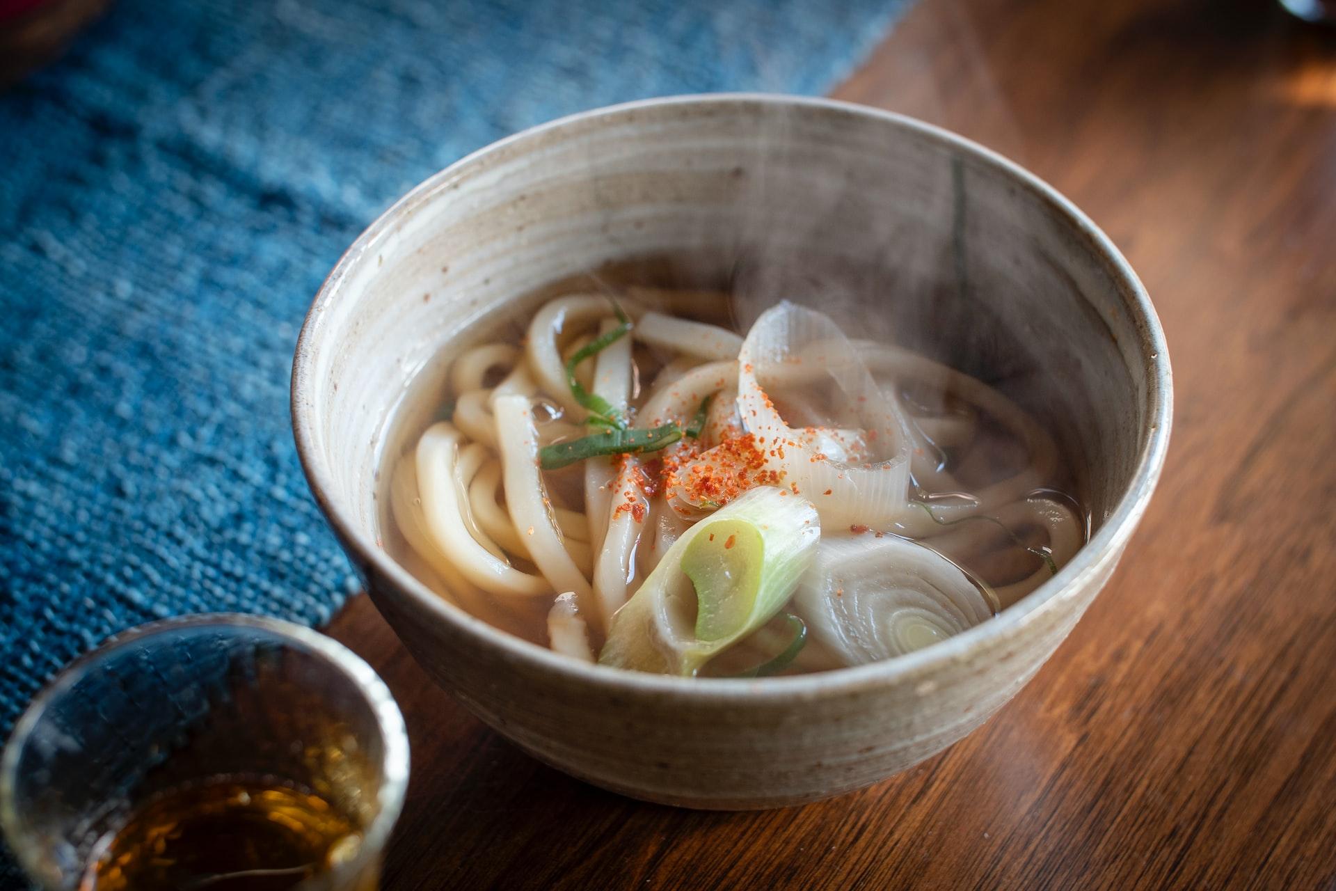 a bowl of soup with noodles and vegetables