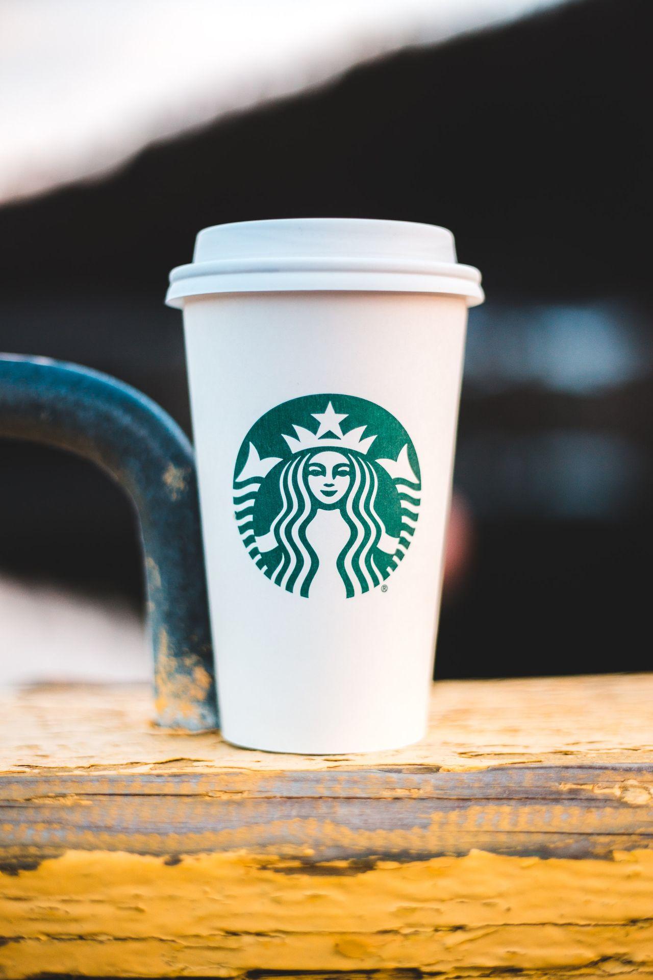 white and green starbucks cup on brown wooden table