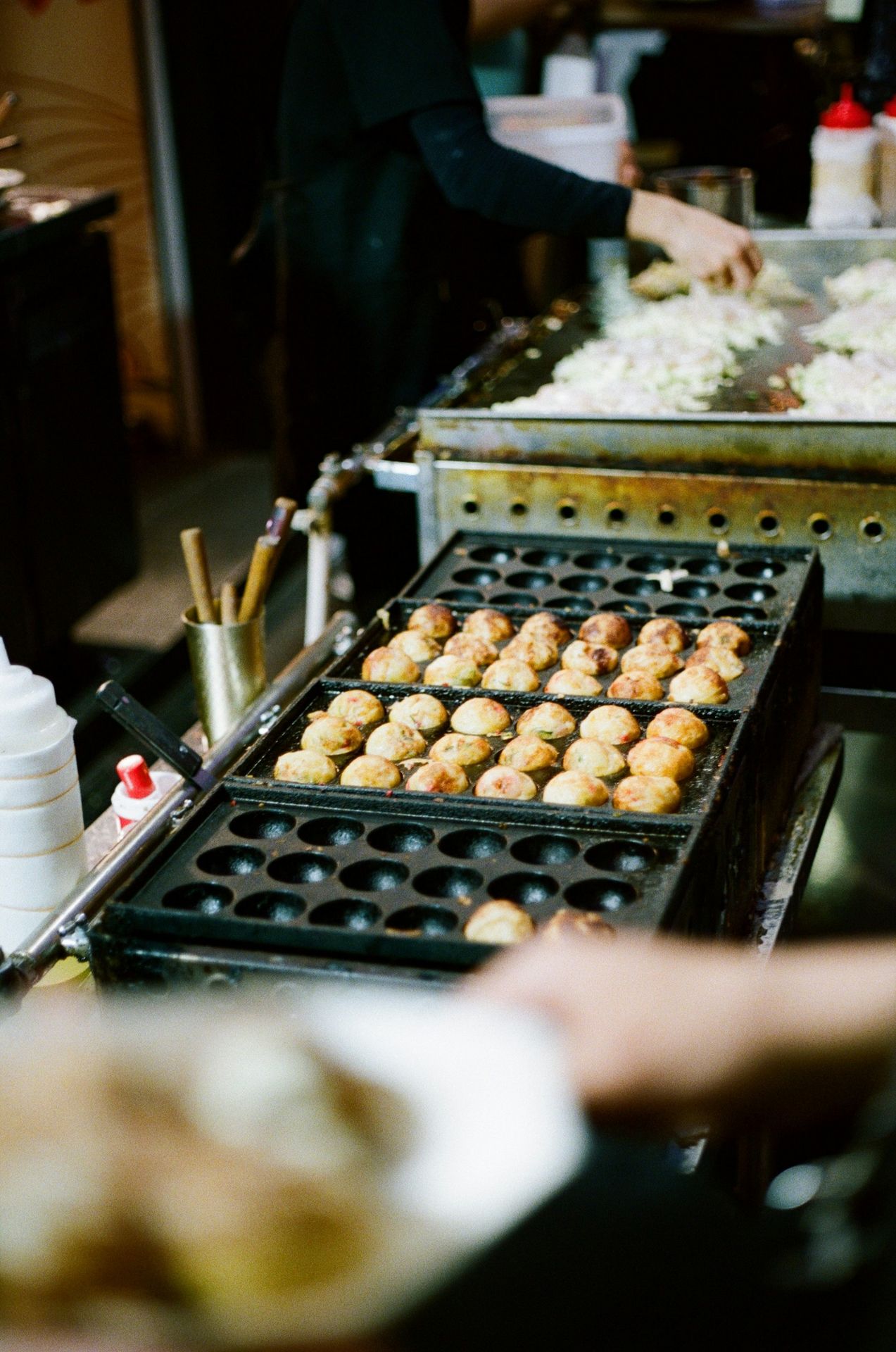 A buffet line of food being prepared for consumption