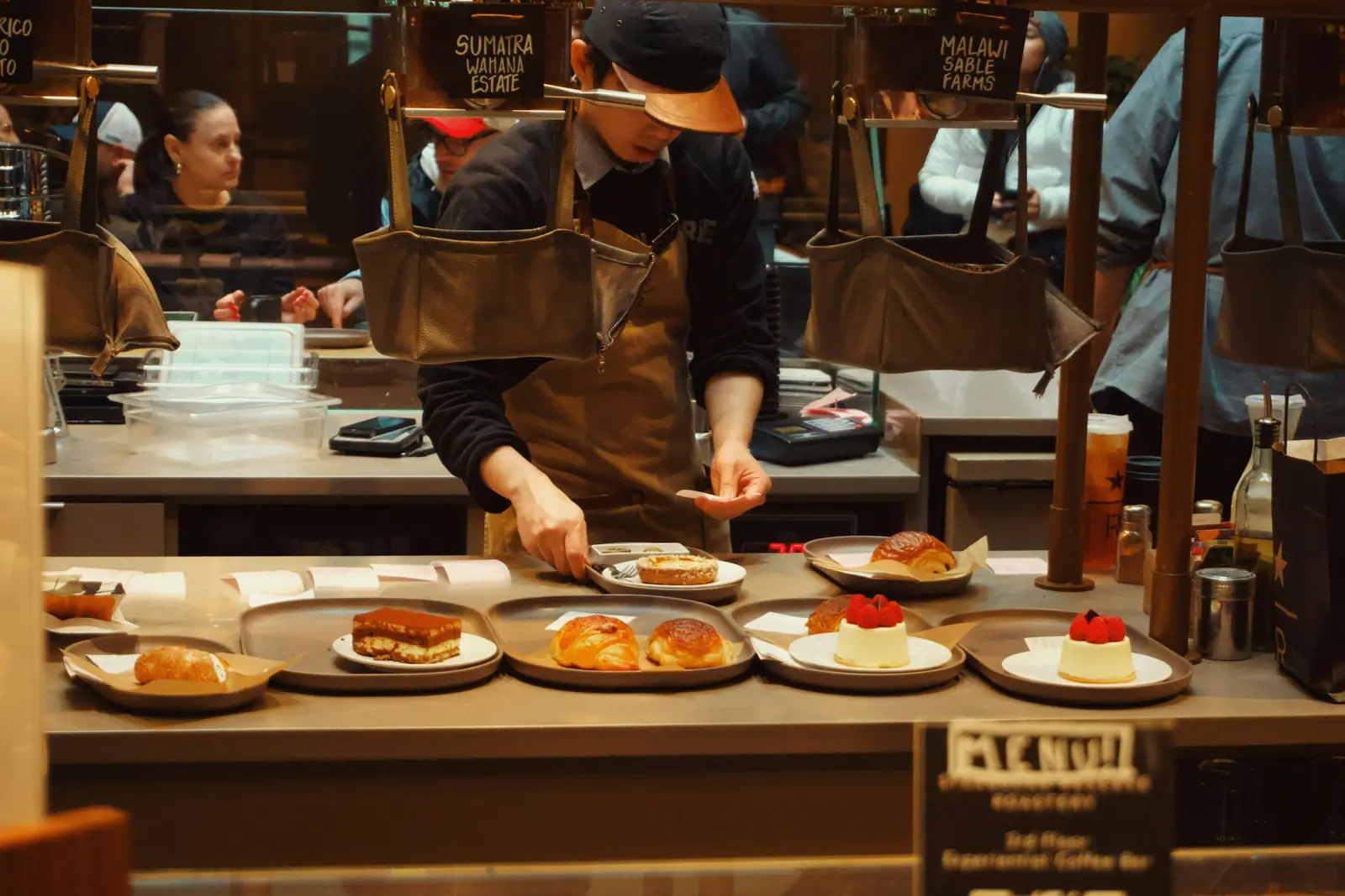 A pastry chef finishing desserts in a professional kitchen