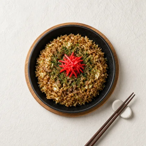 Sobameshi, chopped yakisoba noodles fried with rice and sauce on an iron plate