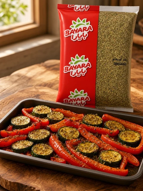 Tray of roasted peppers and courgettes with oregano beside a bag of Bayara Oregano
